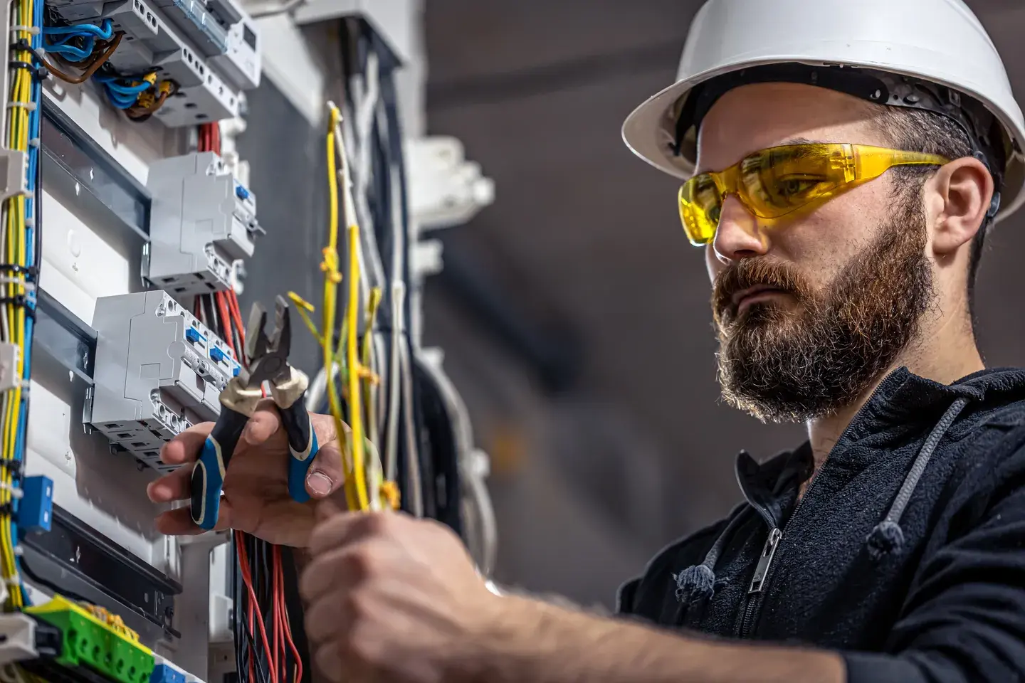 Picture of an electrician working with an electrical panel